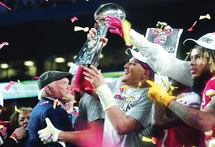 Patrick Mahomes holding the Lombardi Trophy after a win over the 49ers  Superbowl LIV